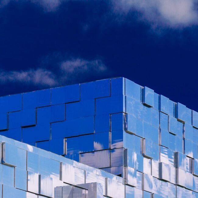 a blue building with a sky background