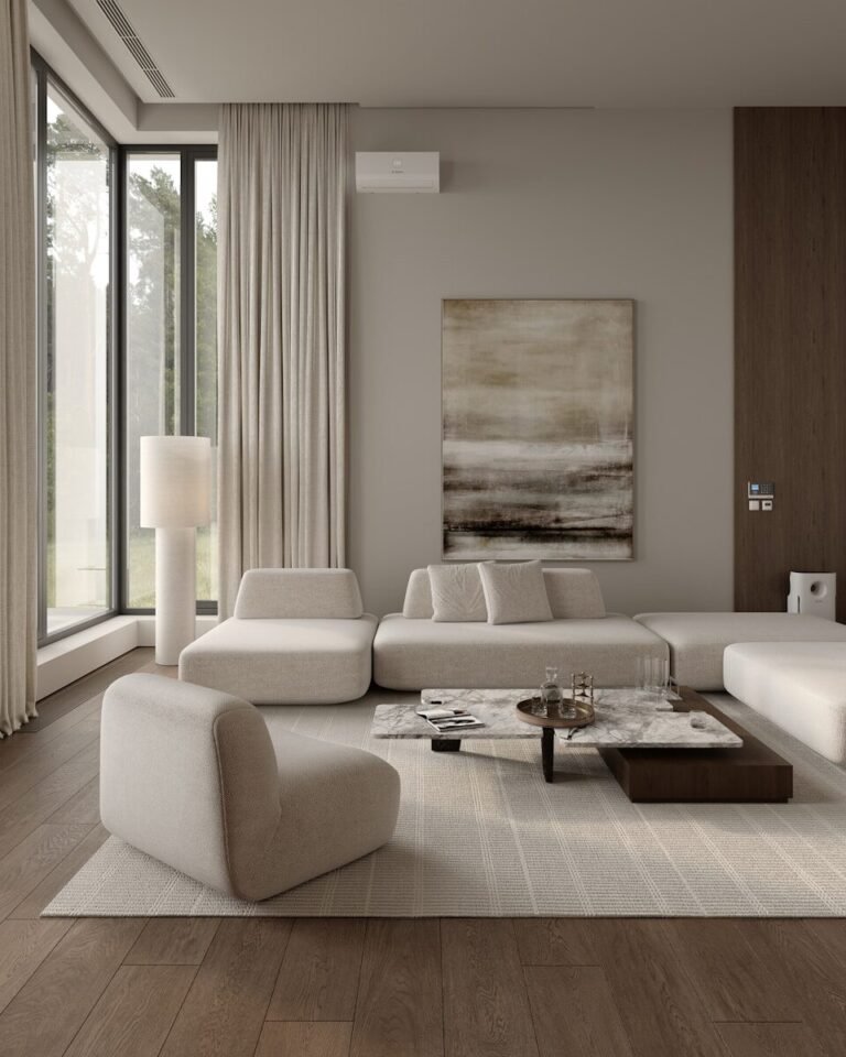 Modern living room with white furniture, large window, abstract painting.
