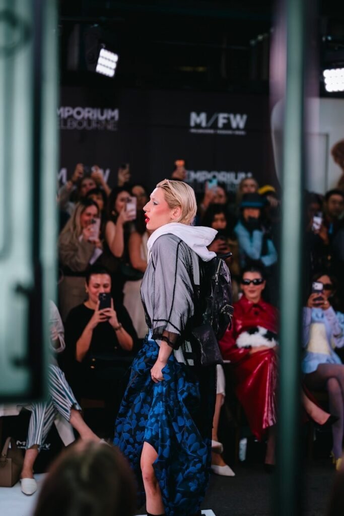 Woman walking on runway with audience watching