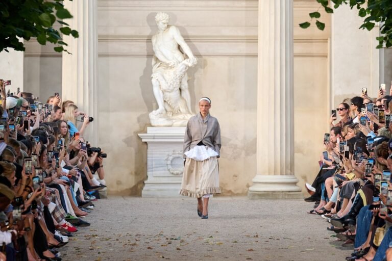The open-air show in the King's Garden, a formal, historic Copenhagen setting, featured models alongside friends of the house and new faces, making the presentation feel like an expanded version of the brand's own community.