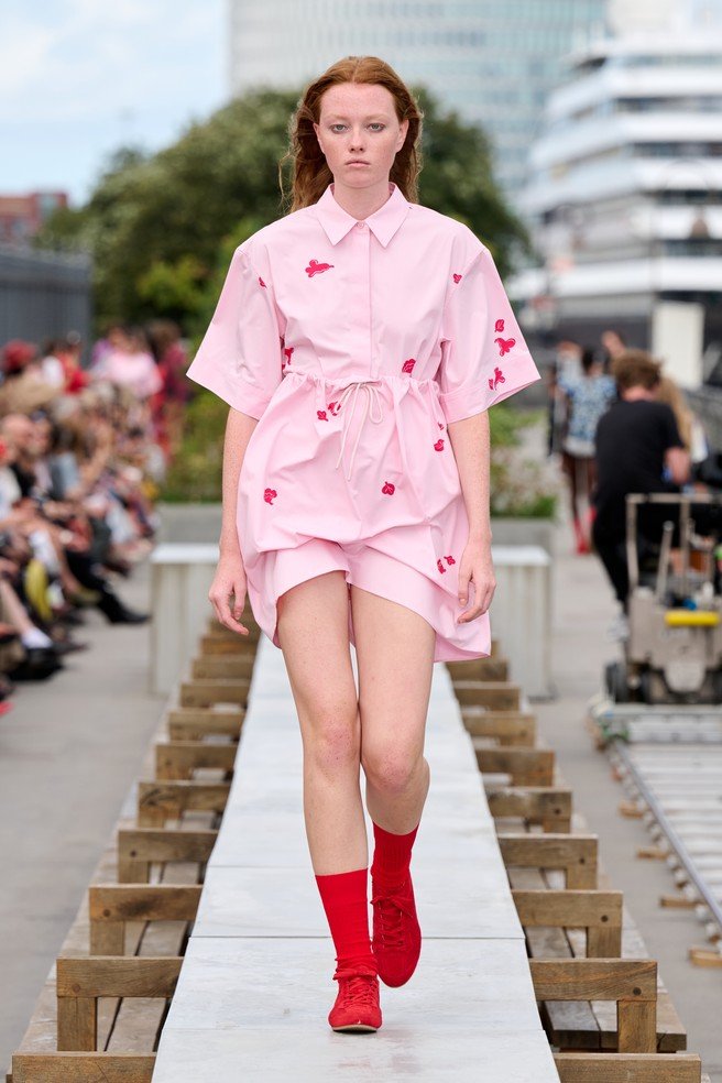 Marimekko, a Finnish design company renowned for its original prints and colors, came to Copenhagen with a different advantage: owning visual assets strong enough to do the introduction before the press release begins. They transformed a concrete communal dining table on the rooftop of the historic Langelinieskuret into a runway, while the SS27 theme, The art, the artist, and the landscape, was delivered through recognizable colors, abstracted florals and stripes, and forms inspired by desert terrain.