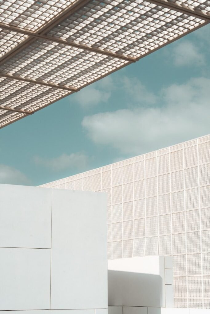 Modern white architecture under a patterned roof and blue sky