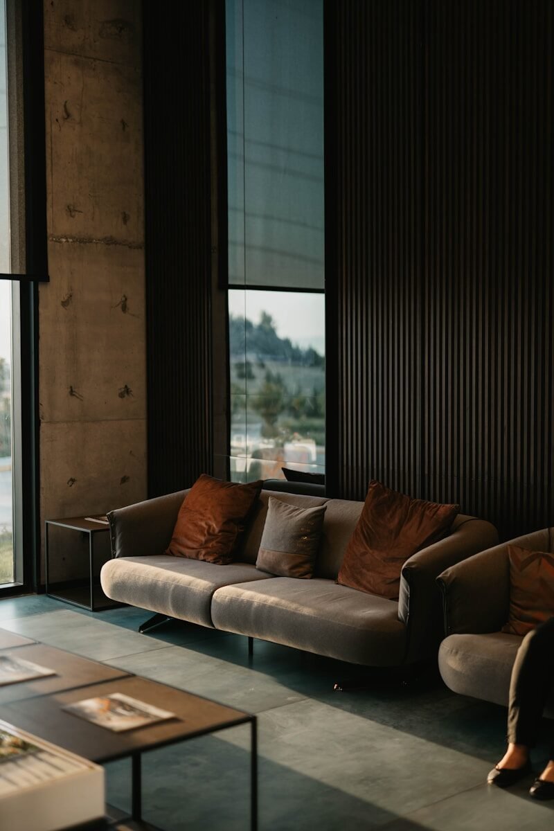 brown and white couch beside window