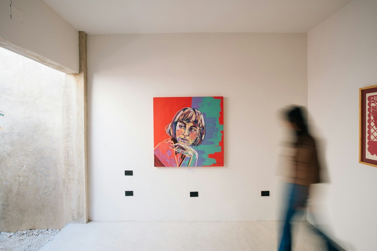 Painting of a woman hanging on a white wall